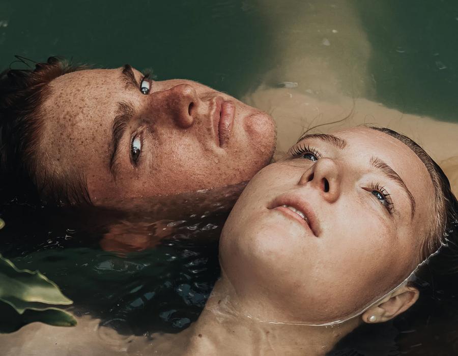 Two individuals floating calmly in water with natural skin texture visible, symbolizing skin harmony, hydration, and holistic skincare by ORY Skincare.