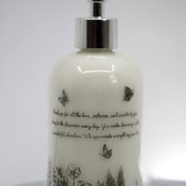 ORY Botanical Garden glass lotion bottle with personalized message, ivory glass finish, delicate wildflower illustrations, and polished silver pump.