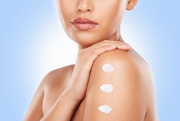 Close-up of moisturized skin with layered skincare creams on the shoulder, representing ORY Skincare’s ingredient transparency, formulation process, and skin-first philosophy.