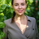 Woman standing among lush green leaves — natural beetroot extract and botanical skincare inspiration by ORY Skincare.