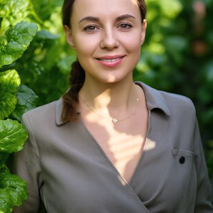 Woman standing among lush green leaves — natural beetroot extract and botanical skincare inspiration by ORY Skincare.
