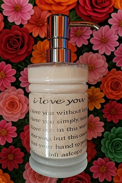 Handcrafted ORY Skincare lotion bottle with engraved message, surrounded by vibrant botanical flowers, symbolizing love, intention, and artisanal skincare.