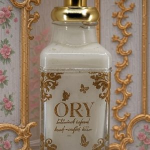 ORY Skincare personalized lotion bottle in rococo style featuring ornate gold detailing, handcrafted botanical-infused lotion, and vintage floral design.