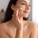 Woman gently applying acne gel to her cheek, demonstrating a lightweight, calming treatment for clear skin by ORY Skincare.
