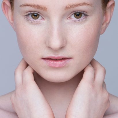 Woman with naturally sensitive skin in a soft studio portrait, representing ORY Skincare’s customized sensitive skincare routine.