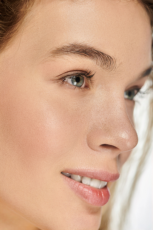Close-up of a woman with smooth, hydrated dry skin and a natural glow, illustrating balanced moisture and healthy skin texture for ORY Skincare dry skin solutions.