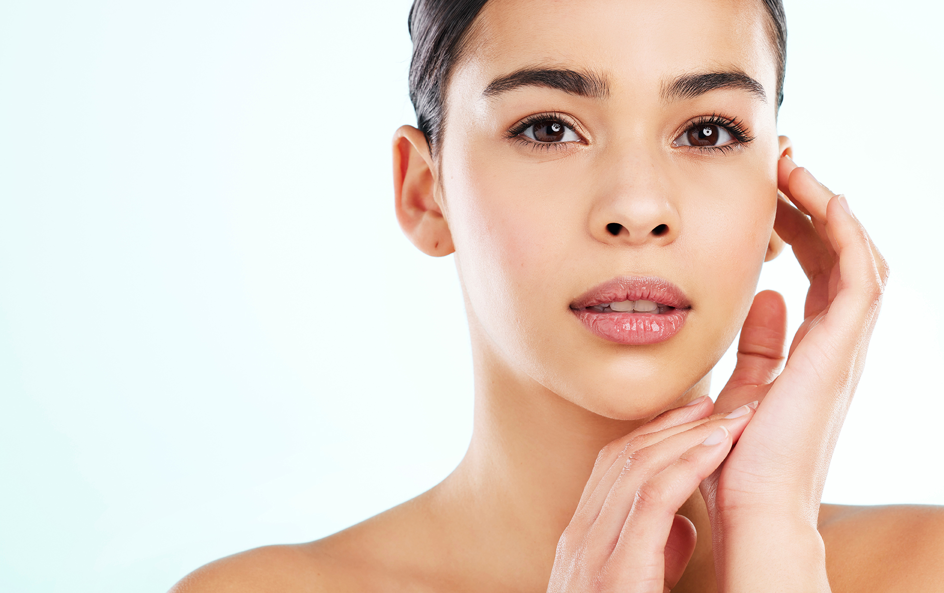 Young woman with naturally sensitive skin in soft light, showcasing ORY Skincare’s gentle and customized sensitive skincare solutions.