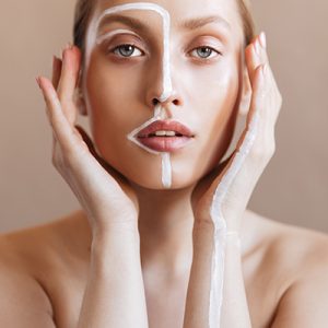 Woman highlighting T-zone and dry areas on face — ORY Skincare balancing cleanser for combination skin.