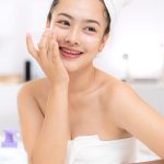 Woman cleansing her face with gentle foaming cleanser — ORY Skincare formula for normal skin.