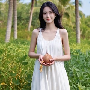 Woman in a lush botanical field holding a coconut, symbolizing the emulsifying and stabilizing benefits of Glycerol Monostearate-SE in ORY Skincare formulations.