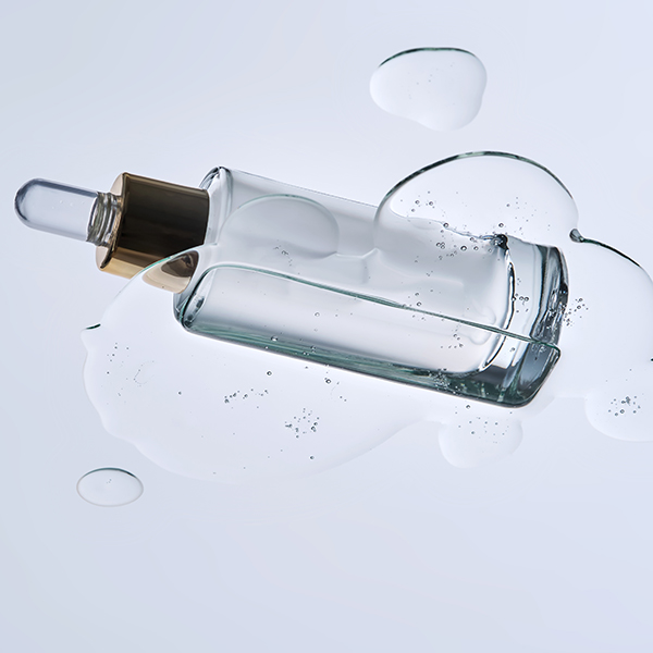 Clear bi-phasic skincare serum in glass dropper bottle showing oil and water phases, representing ORY Skincare’s botanical bi-phasic infusion technology.