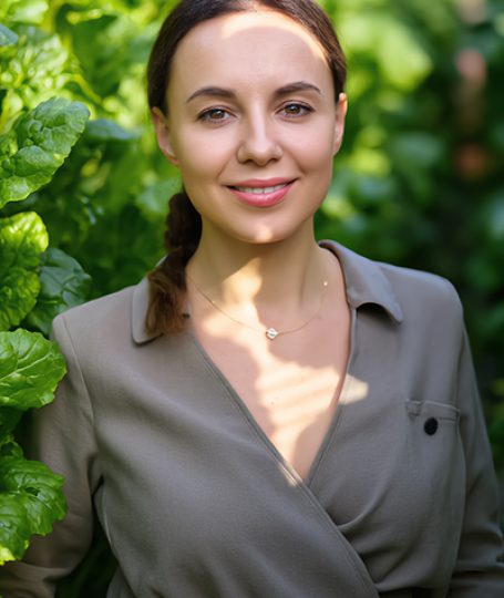 Woman standing among lush green leaves — natural beetroot extract and botanical skincare inspiration by ORY Skincare.